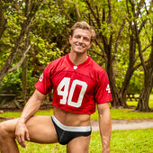 Red cropped football jersey with white number 40 and mesh fabric texture in men’s fabric guide article