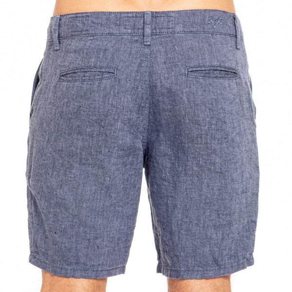 Back side of blue heathered denim shorts with classic pocket design featured in linen slim fit shorts article