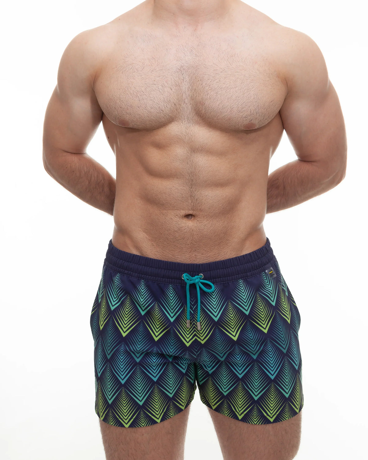 Navy blue along peacock swim trunks with vibrant teal and lime green chevron pattern and turquoise drawstrings.