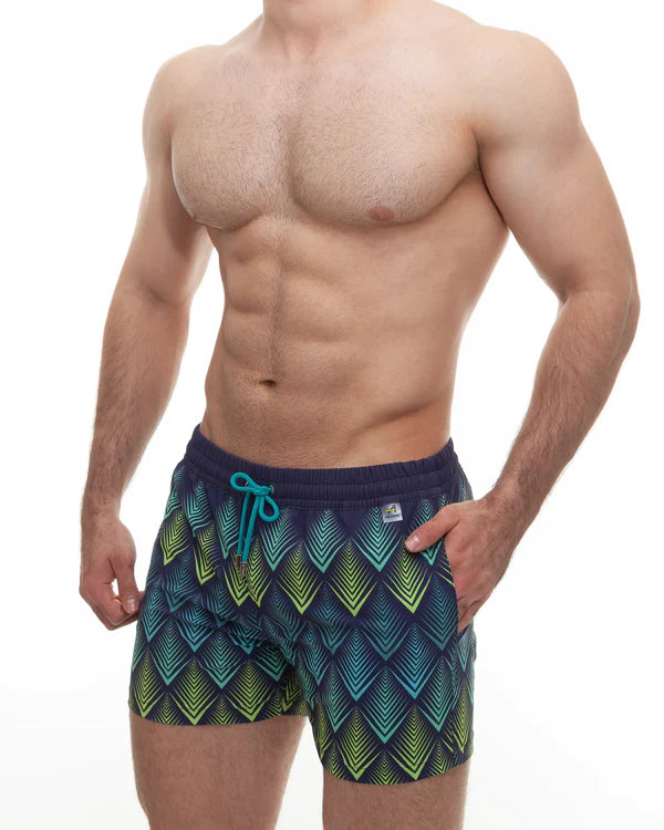 Men’s swim trunks with bold teal green and navy geometric pattern and turquoise drawstrings for a trendy summer look