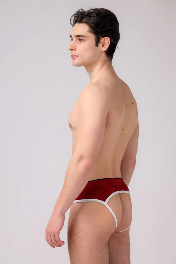 A man wearing burgundy and white as me jockstrap briefs with white trim for ultimate support and comfort.