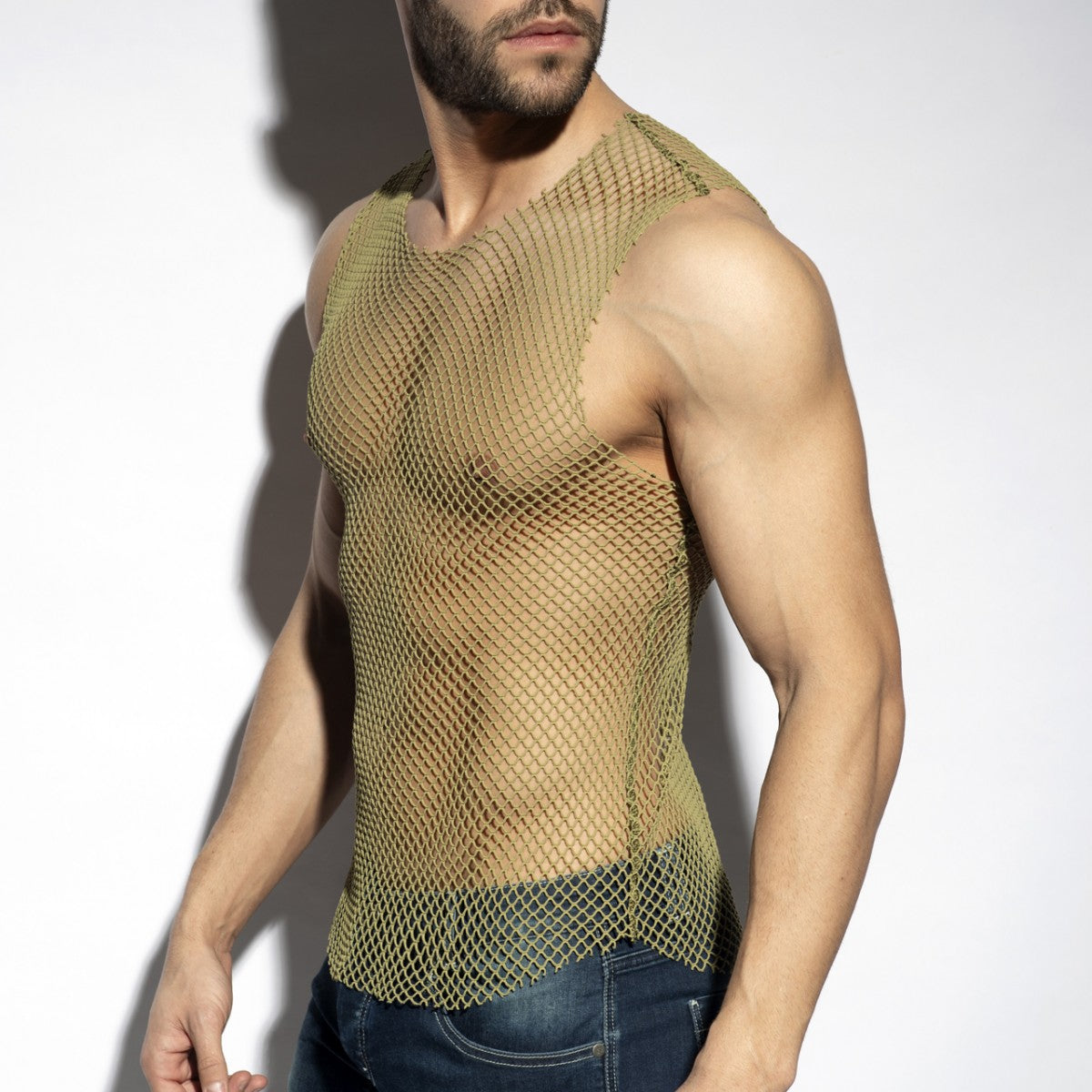 Olive green mesh tank top showcasing breathable material in an article about celebrating identity and queer fashion brands