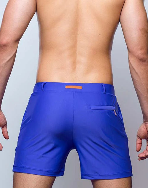 Vibrant royal blue bondi short swim trunks with subtle orange waistband accent and sleek modern design