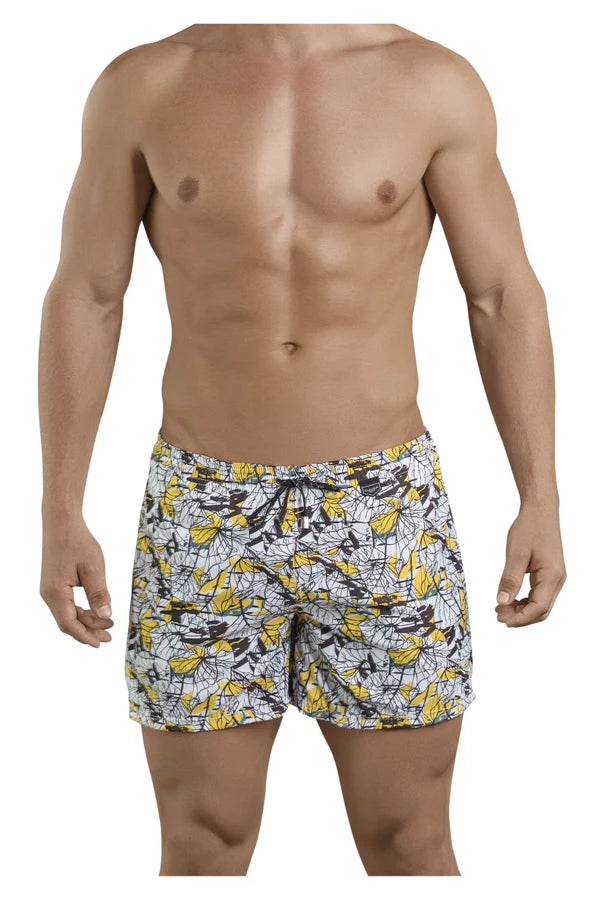 White swim trunks with vibrant yellow and black abstract leaf pattern featured in the ultimate guide to athletic shorts