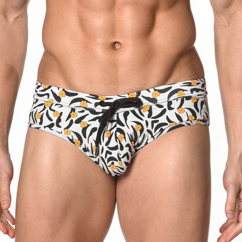 White swim trunks with black and yellow floral pattern and black drawstring waistband in tiger freestyle style