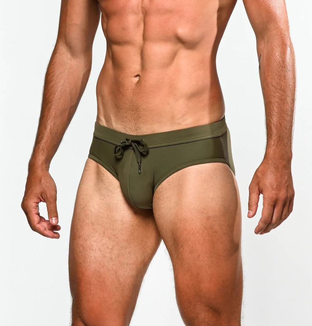 Olive green army swim trunks with drawstring waistband designed for freestyle swimming and active water use