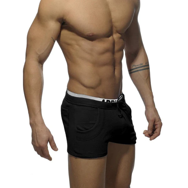 Black athletic shorts with white combined waistband featuring bold arrow branding for stylish and comfortable wear