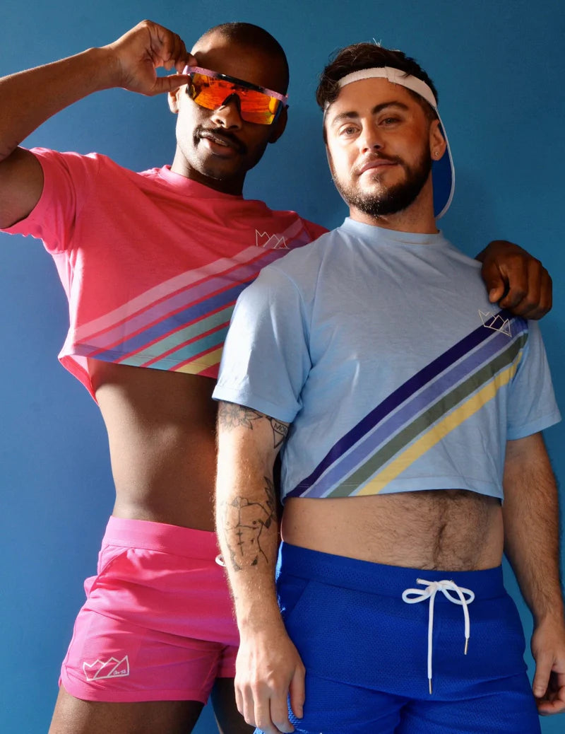 The trendy retro stripe crop tops in vibrant pink and light blue feature bold rainbow diagonal stripes on lightweight fabric.