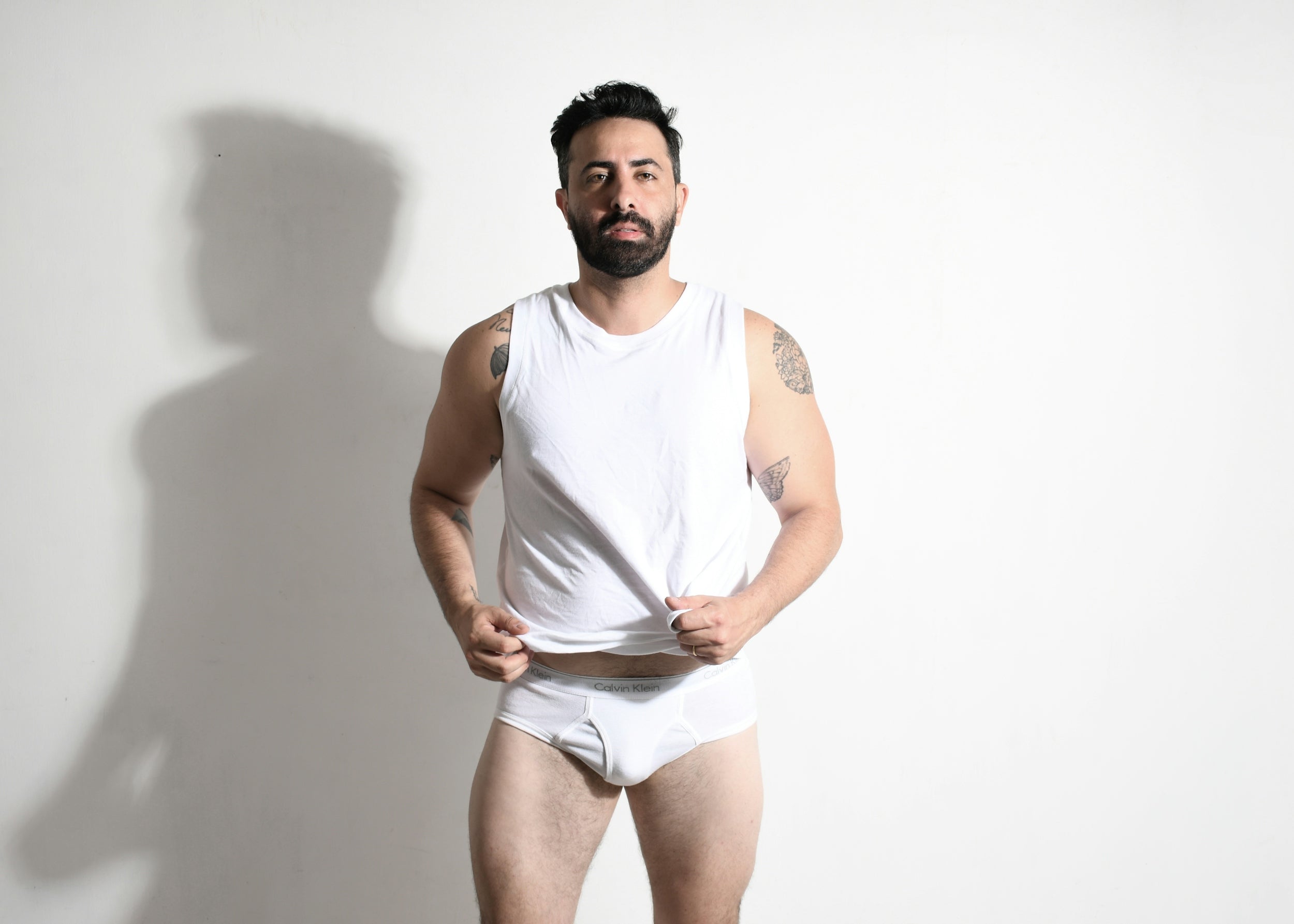 White cotton tank top with round neckline and sleeveless design for queer-positive everyday comfort