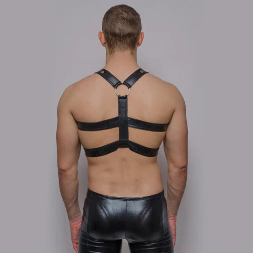 Black leather harness with central ring and adjustable straps featured in tartarus faux leather ring harness article