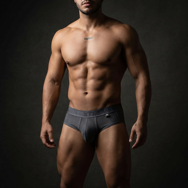 Muscular man in Xtremen branded microfiber underwear, dramatic studio lighting, bold men's underwear editorial