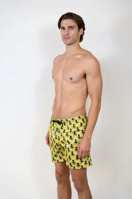 Bright yellow swim trunks with a black octopus pattern from the silver stone swim shorts collection