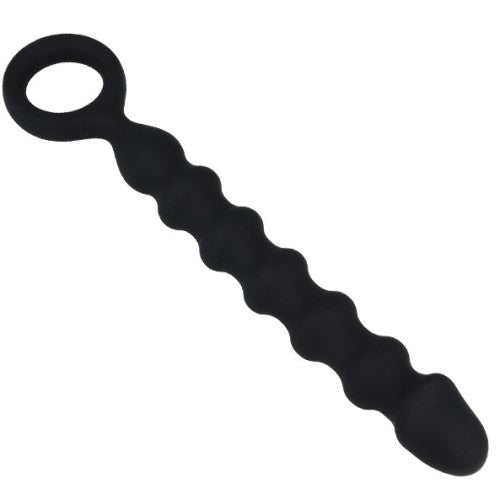 Black textured mens gear with pronounced surface detail in a dark, assertive fetish aesthetic setting.