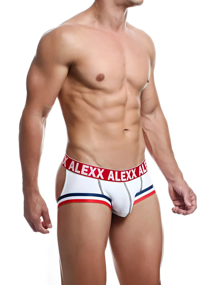 A muscular man wears white, red, and blue open-back briefs on white.