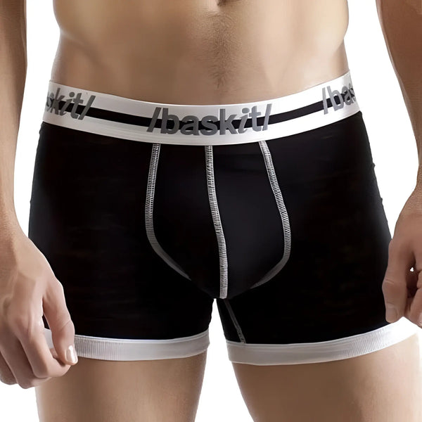 Black boxer briefs with white trim worn by a man, studio white background.