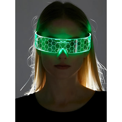 Blond woman wears glowing green hexagonal visor glasses against a gray background.