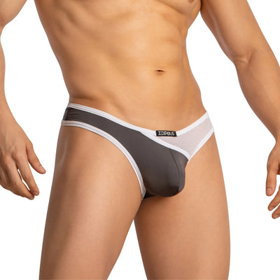 Torso of man wearing grey and white mesh brief on white background.