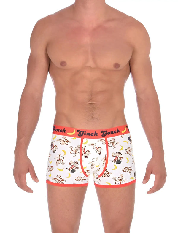 Muscular shirtless man wears white boxer briefs featuring monkey and banana prints.