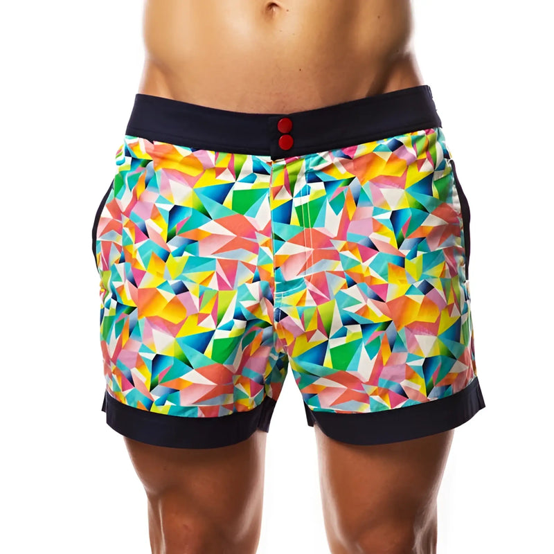 Colorful geometric pattern swim shorts with black waistband against white background.
