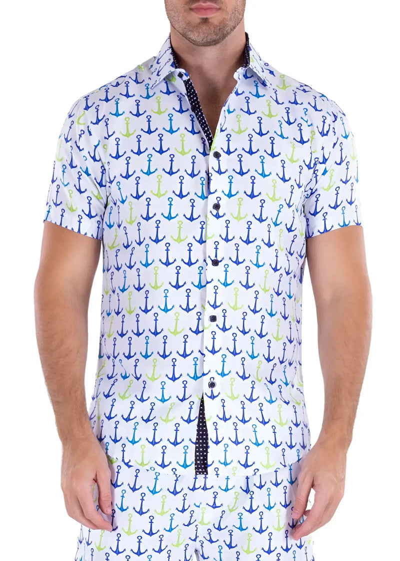 A man wears a short-sleeved white button-down shirt featuring blue-green anchors.