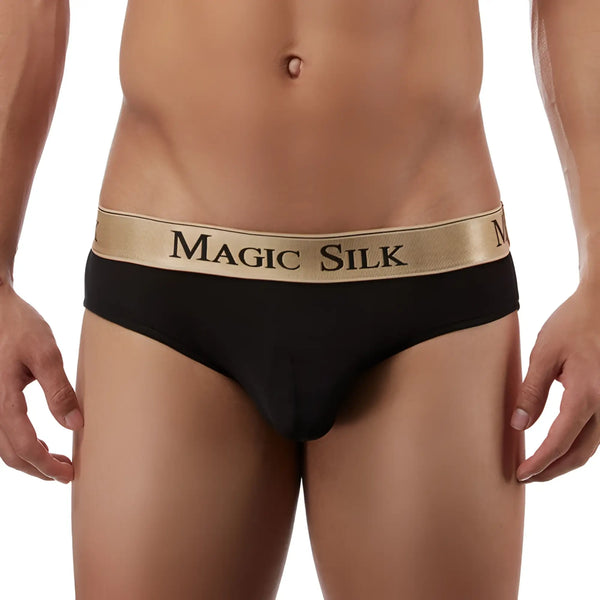Torso of a man wearing black underwear with a gold elastic waistband.