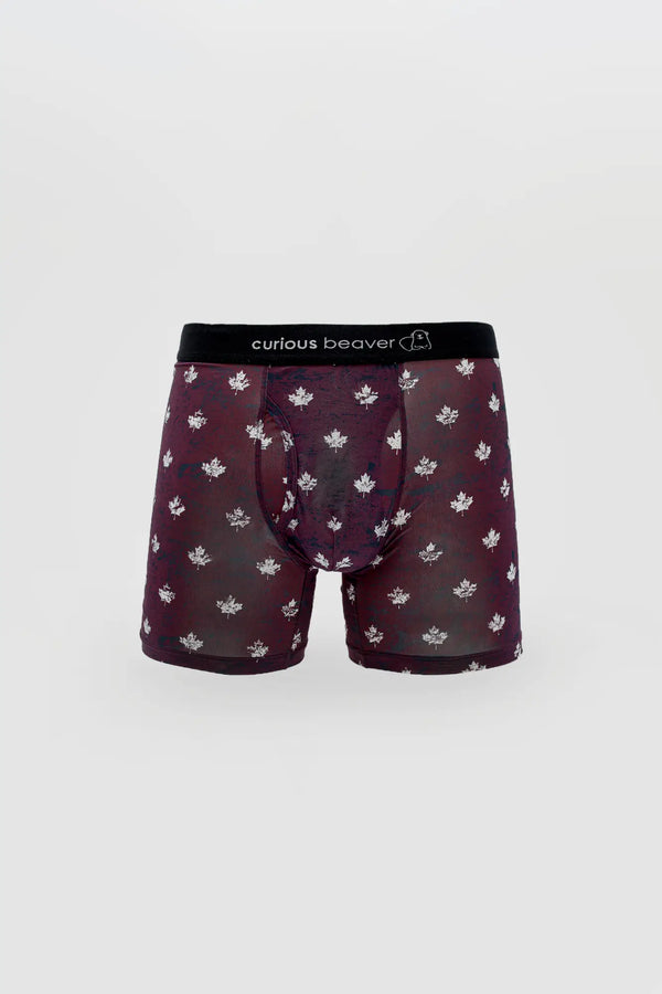 Burgundy boxer briefs with white maple leaf print and black elastic waistband.