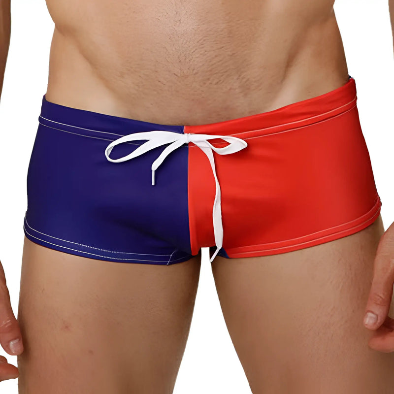 Man wears blue and red swim trunks with a white drawstring tie.
