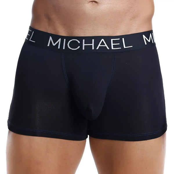 Black boxer briefs with elastic waistband worn by model against white background.