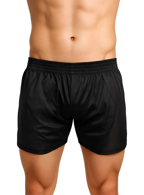 Toned torso wearing shiny black athletic shorts with elastic waistband on white.