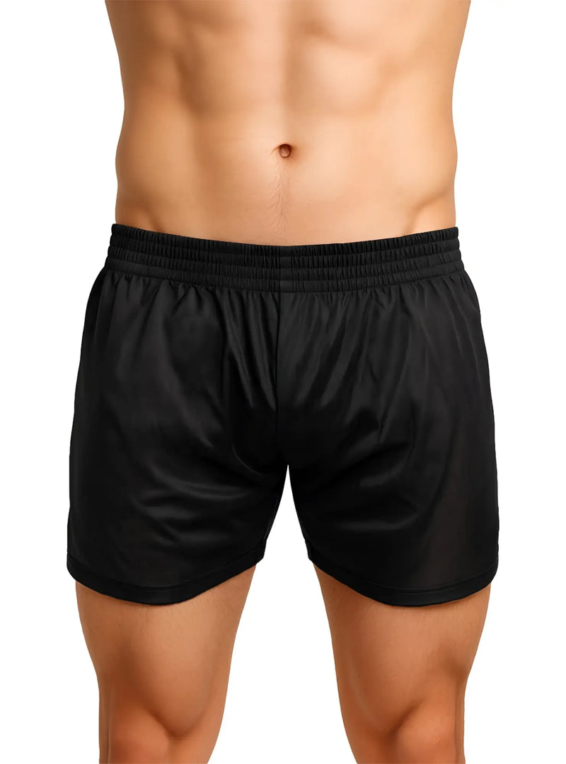 Toned torso wearing shiny black athletic shorts with elastic waistband on white.