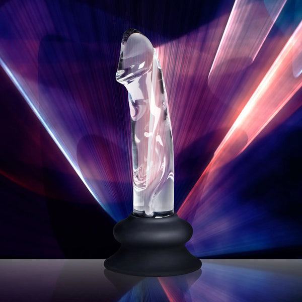 Clear glass object with a black base against a colorful light background.
