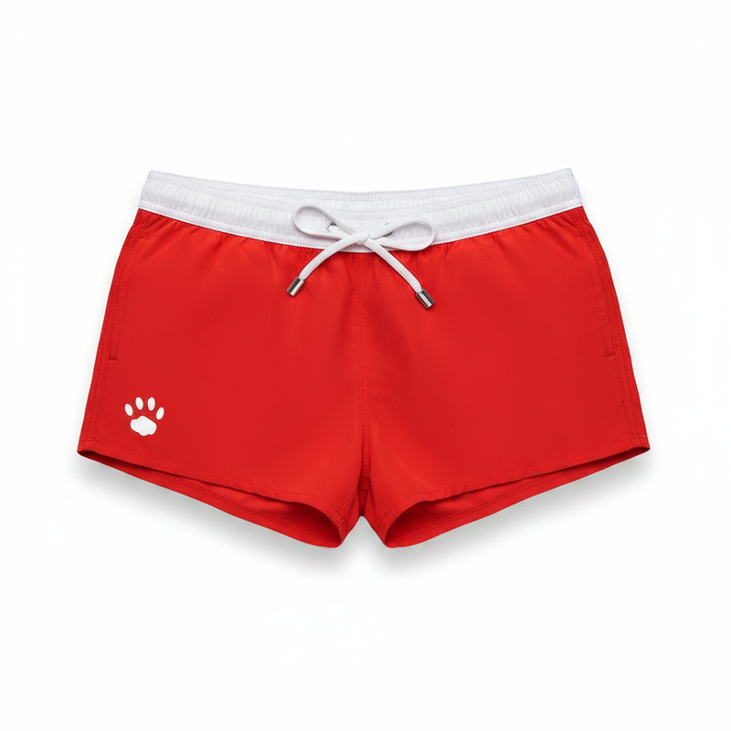 Red swim shorts with white elastic waistband and drawstring featuring a white paw print logo from Prowler Gay collection