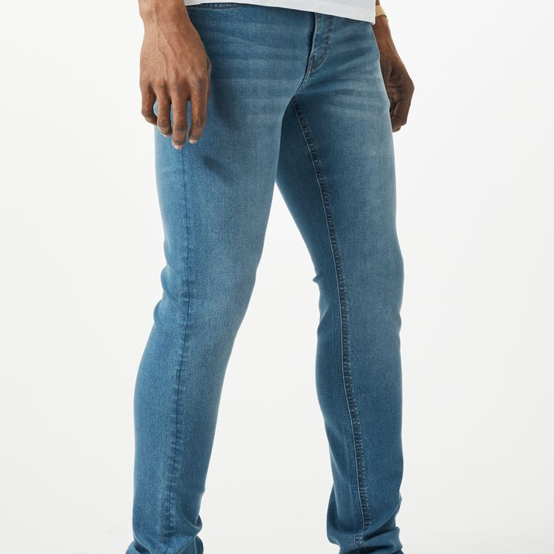 Blue denim jeans with a slim fit and classic stitching from the thread theory collection