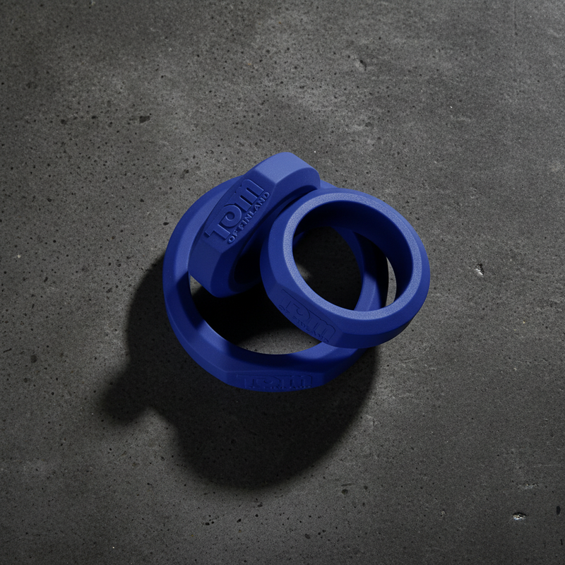 Blue silicone weightlifting collar with textured hexagonal design and embossed branding from tom of finland tools collection