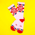 White crew socks with red accents and colorful triangular patterns featuring bold red text 100% that queen