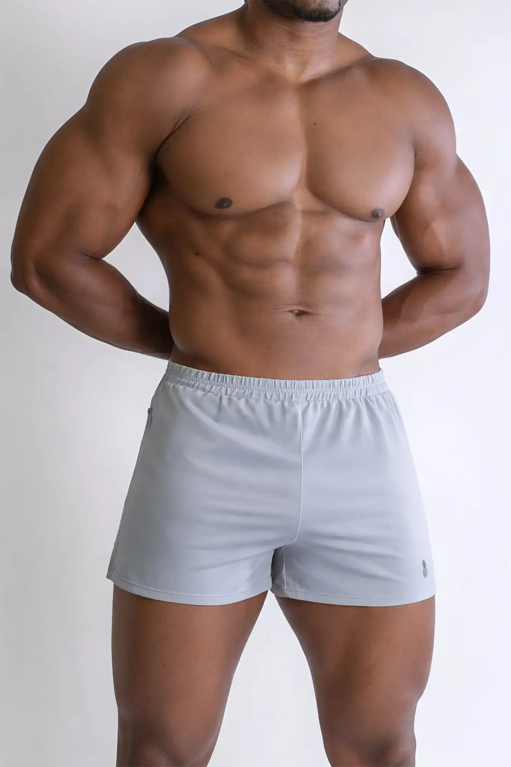 Light gray 2 inch side split booty shorts with elastic waistband and small logo on lower right leg in glacier grey