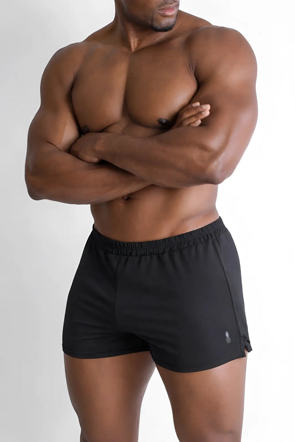 Black athletic 2 inch side split booty shorts in midnight black with subtle logo on the lower right leg