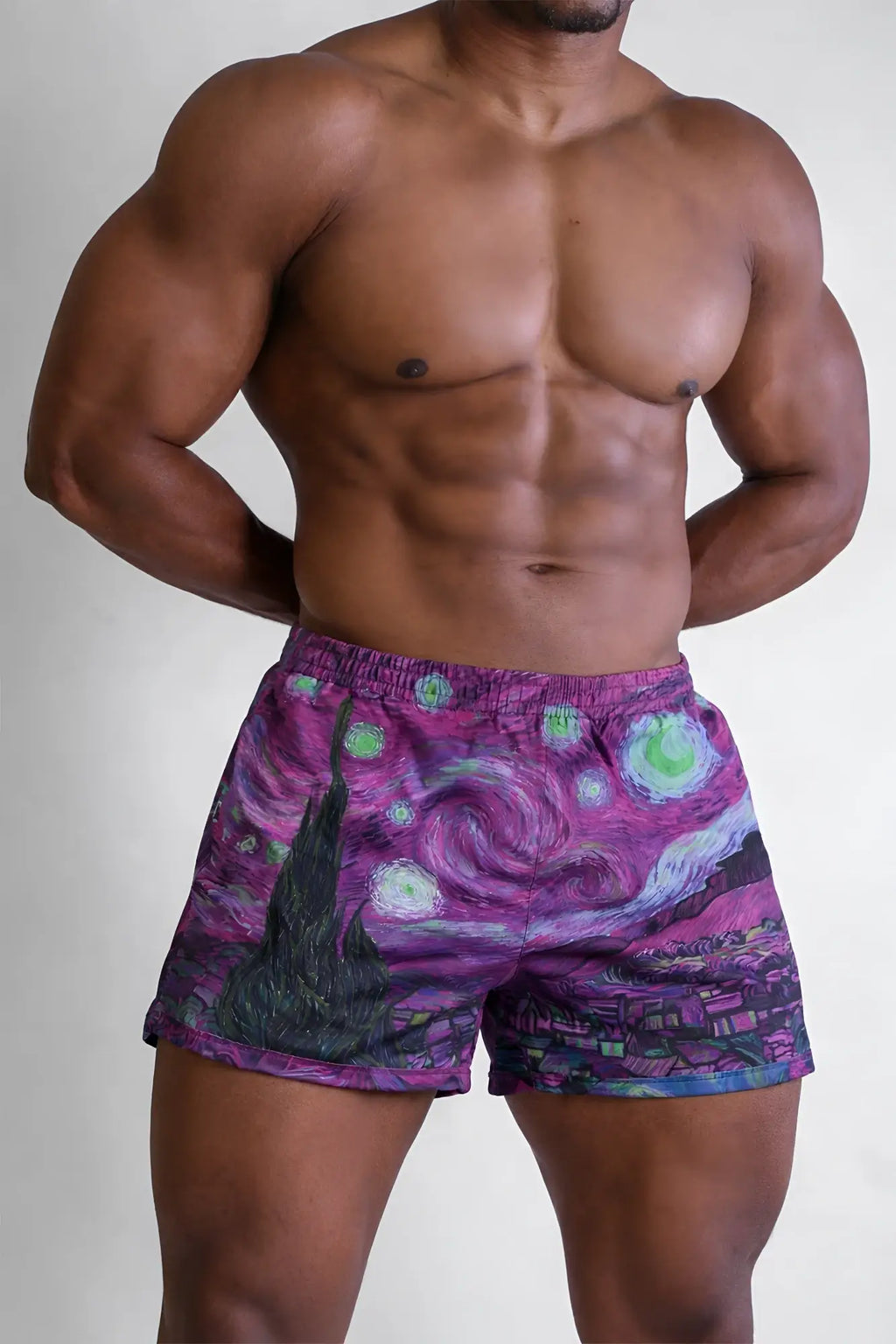 Purple 2 inch side split booty shorts with vibrant swirling starry night design and glowing green stars