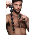 Black silicone vibrating anal beads with textured design and matching remote control for hands-free use