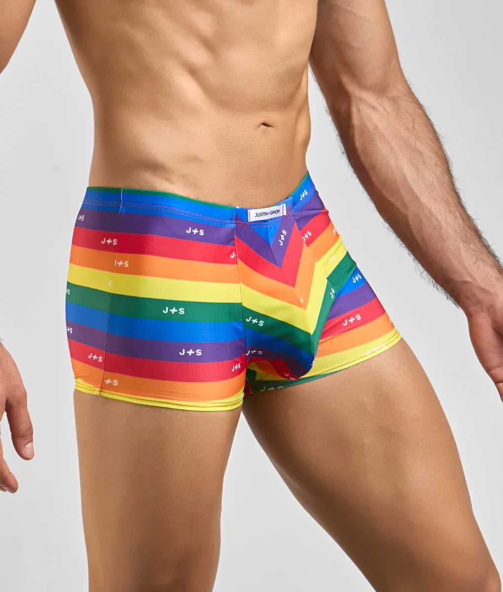 Rainbow-striped men’s boxer briefs with j+s logo printed across the fabric from justin + simon classic boxer collection