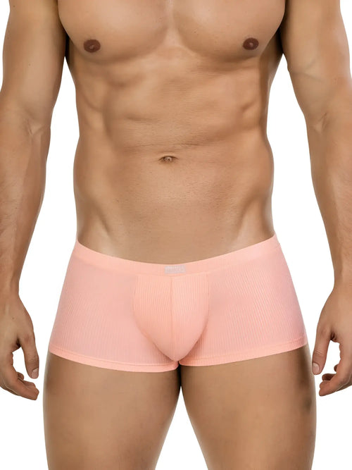 A man wears 26014 Apolo trunks in a light orange, ribbed fabric with a clean, low-rise style.