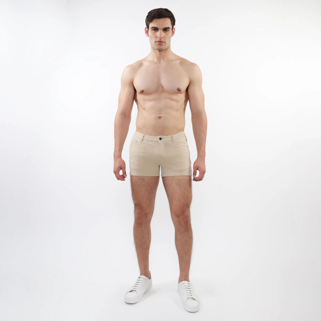 Beige stretch knit chino-style shorts with 3 inch inseam featuring a classic button closure and tailored fit