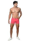 Bright pink 3 inch stretch knit shorts with a form-fitting design and classic button closure