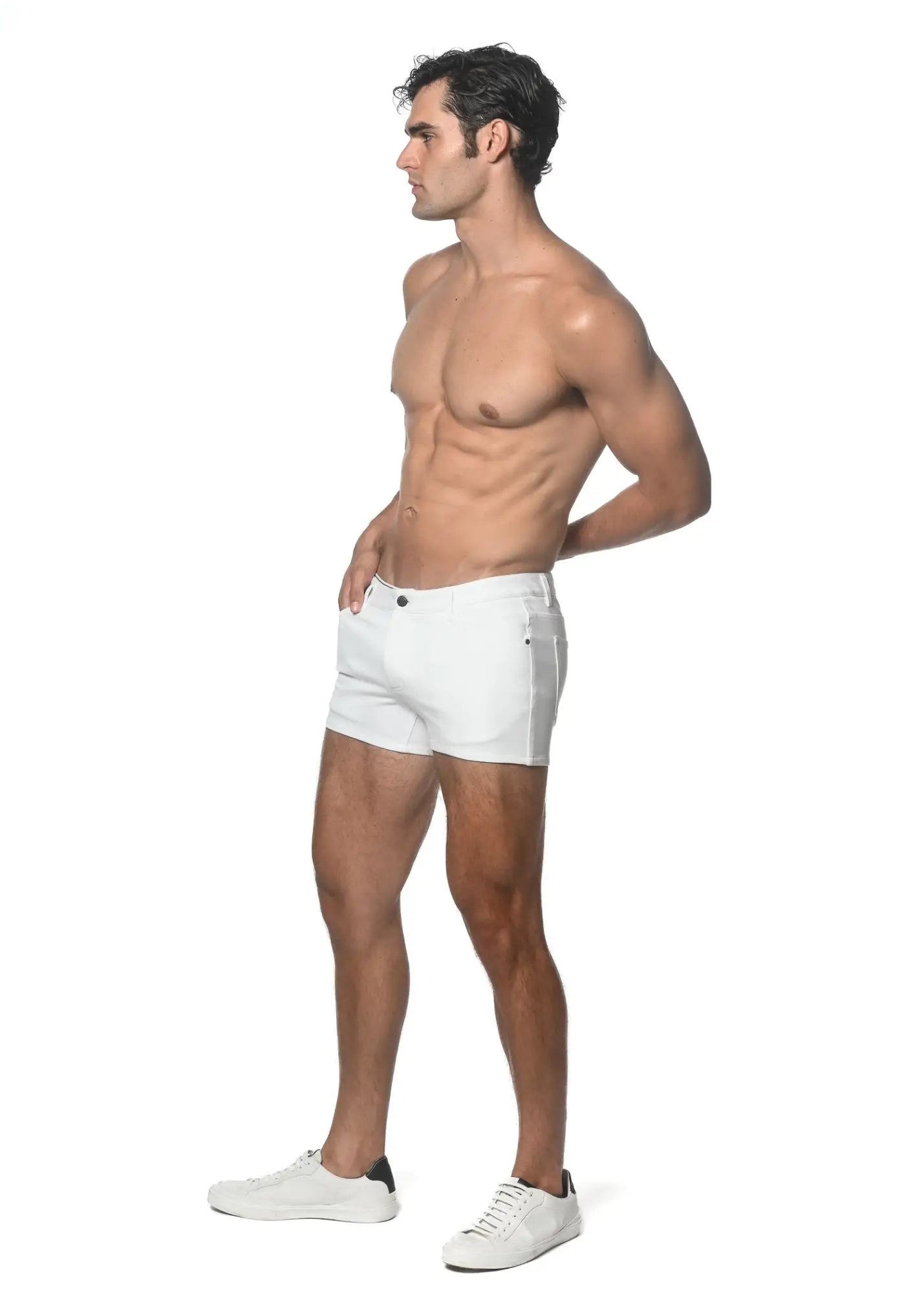 White stretch knit denim shorts with 3 inch inseam featuring classic five-pocket design and button closure