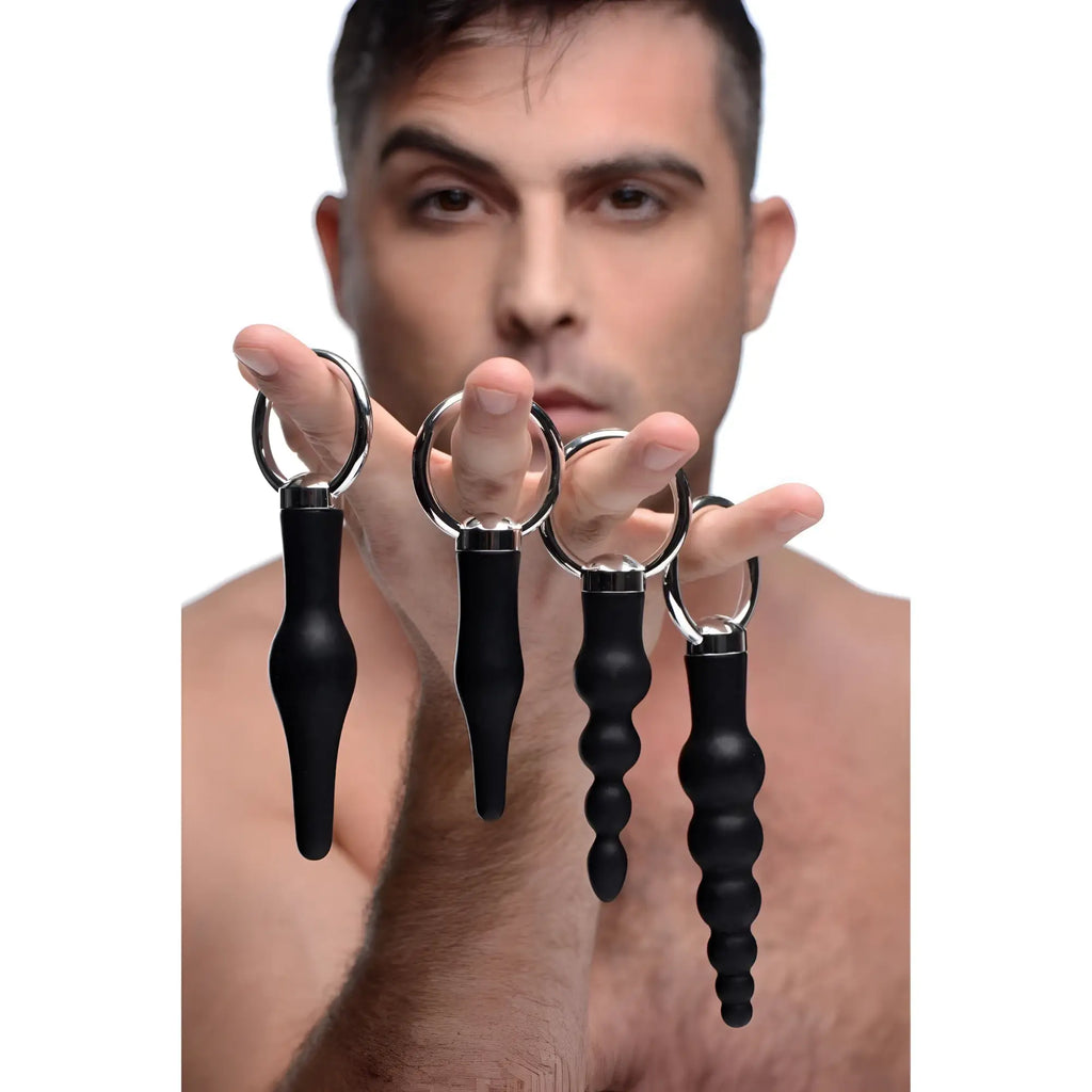 Set of four black silicone anal plugs with silver metal rings from the 4 piece silicone anal ringed rimmer set