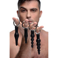 Set of four black silicone anal plugs with silver metal rings from the 4 piece silicone anal ringed rimmer set