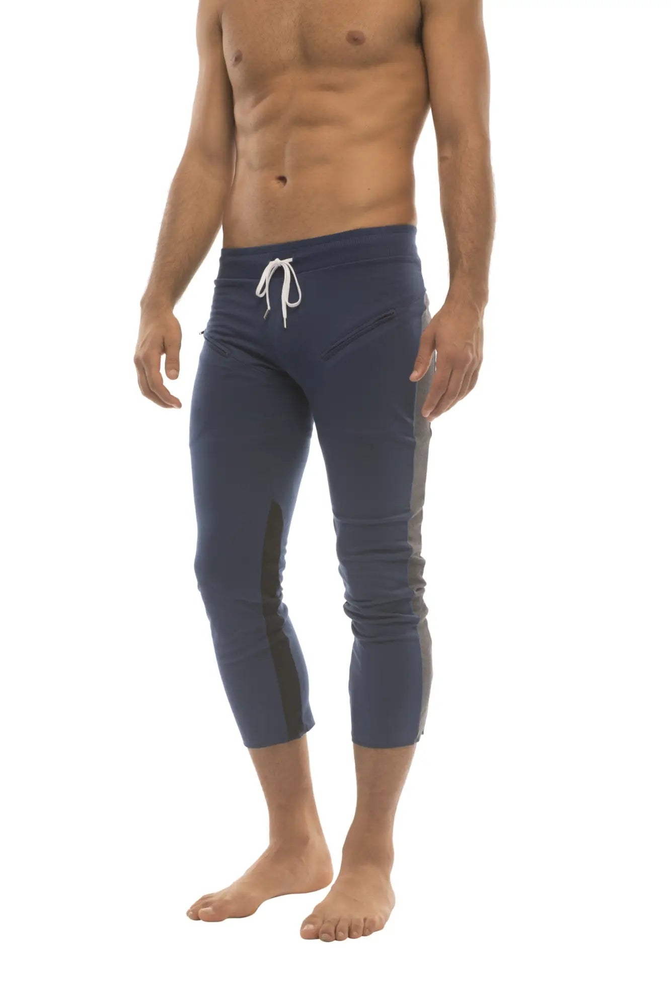 Mens navy blue capri yoga pants with white drawstring waistband black side panels and zipper pockets for active wear
