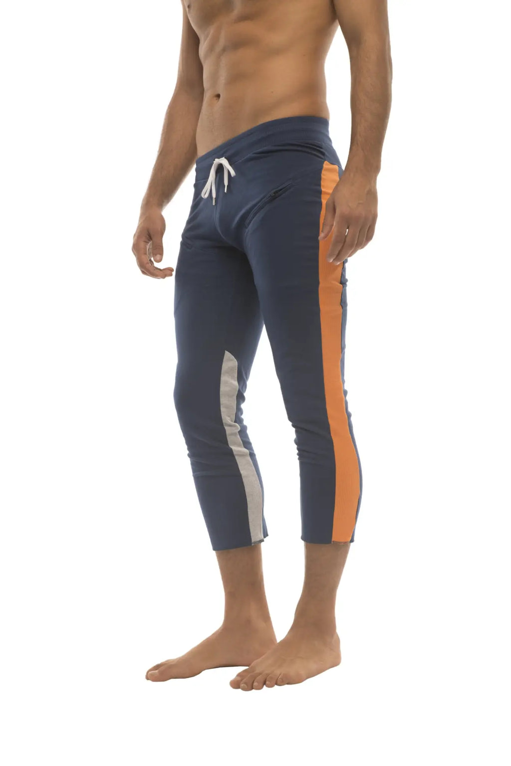 Mens navy blue athletic capri yoga pants with orange and white side stripes and a 4/5 zipper pocket