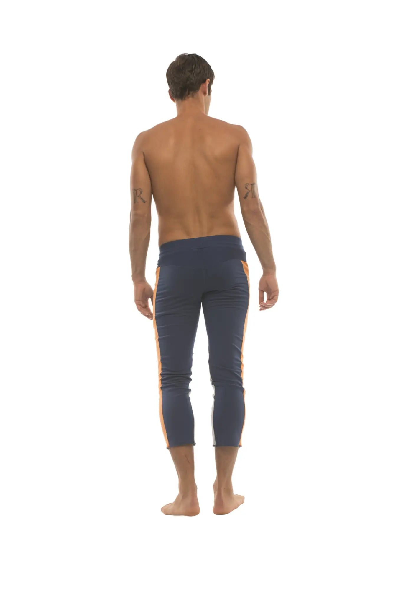 Mens navy blue capri yoga pants with orange side stripes and 4/5 zipper pockets for comfortable activewear