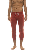 Mens 4/5 zipper pocket capri yoga pants in solid cinnabar red with white drawstring waistband and side pockets